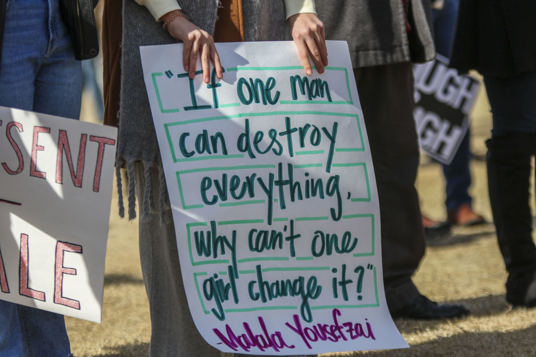 “If one man can destroy everything, why can’t one girl change it? -Malala Yousefzai” sign